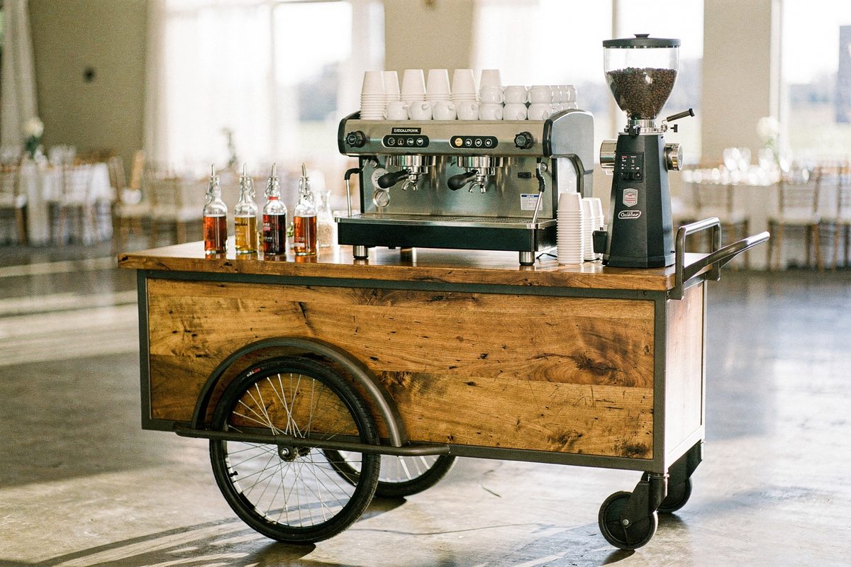 Handcrafted mobile coffee cart with commercial espresso equipment set up at an event venue